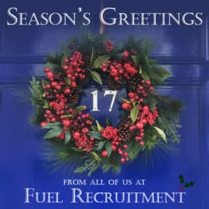 Christmas greeting message with wreathe on a blue door
