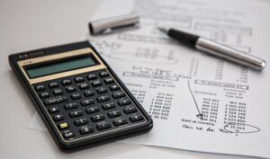 Calculator on a desk with a page of financial information