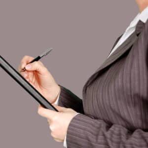 Business person with checklist and pen