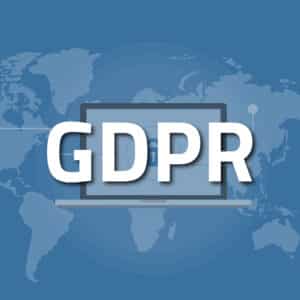 GDPR text over a picture of a laptop with a background of a world map