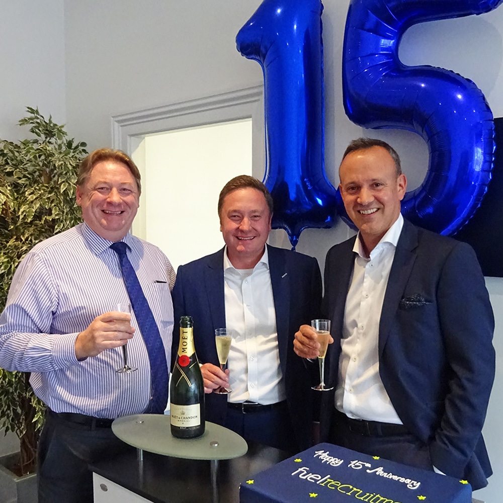 Mark Esom, Steve Willmore and Murray West celebrate 15 years of Fuel Recruitment with champagne, cake and balloons