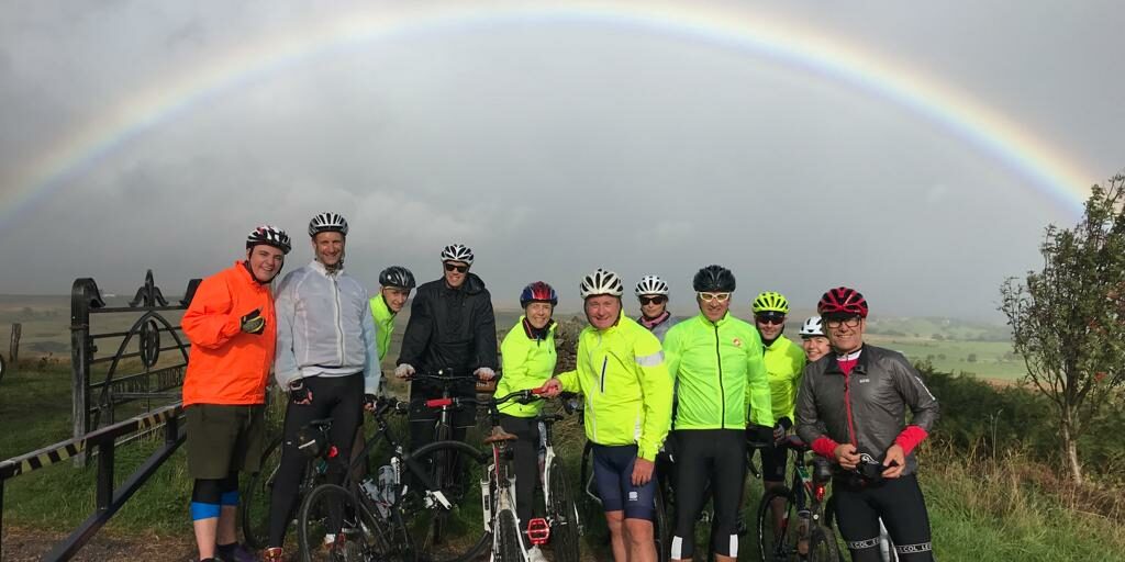 38eabbaf-2051-45b1-a358-f61d0e093807 Members of Fuel recruitment team taking part in a coast to coast charity cycle ride under a rainbow