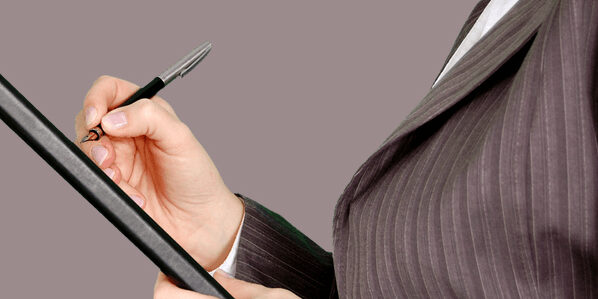 Competency Based Interviews Business person with checklist and pen